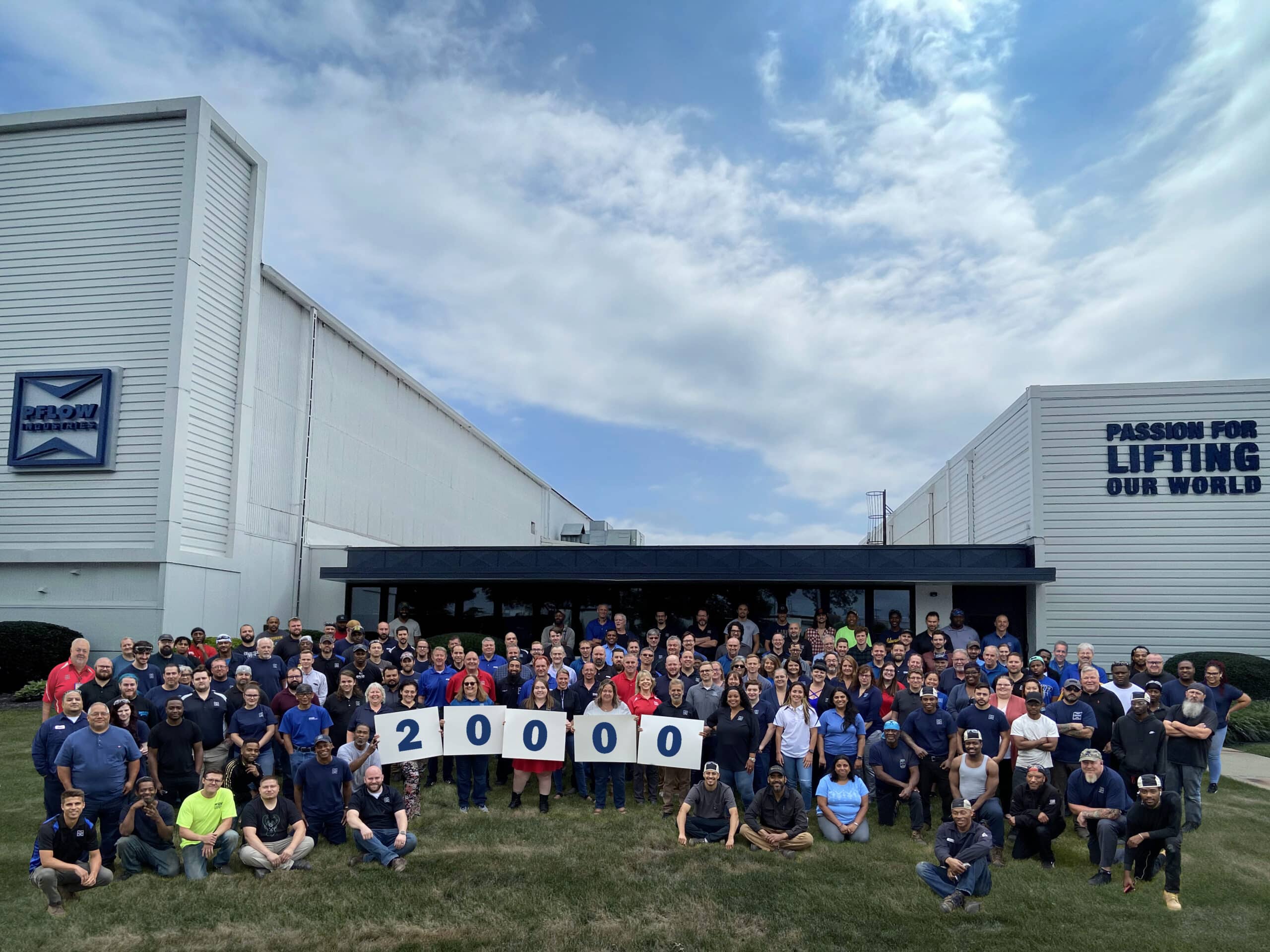 The PFlow team celebrates manufacturing it's 20,000th vertical reciprocating conveyor.