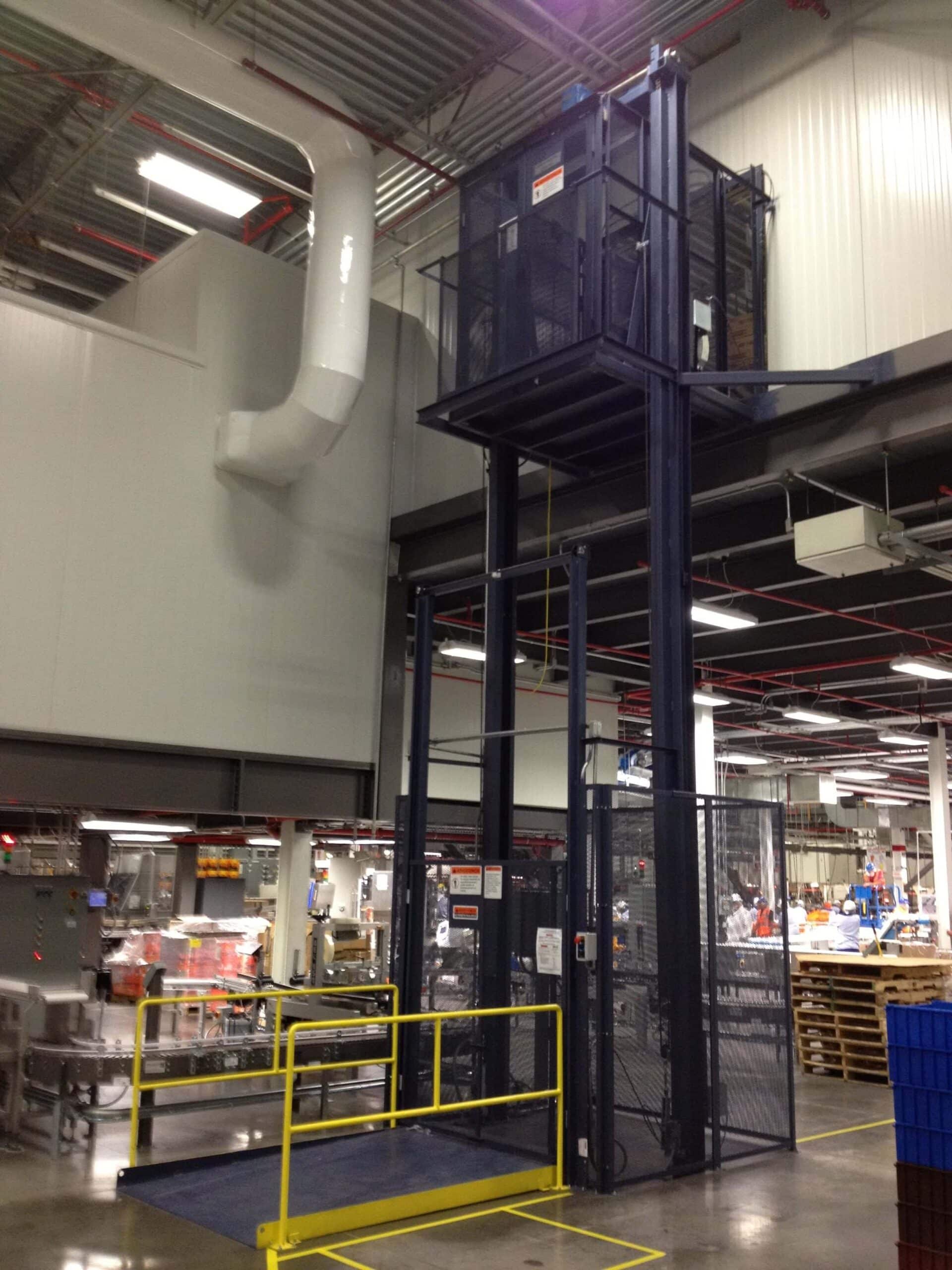 A Pflow Vertical Reciprocating Conveyor being used in a warehouse.