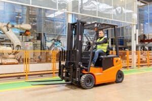 Worker operates a forklift in a warehouse