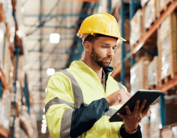Warehouse worker reviewing an inspection checklist